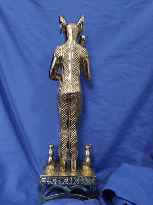 side view of a restored statuette of egyptian goddess bastet